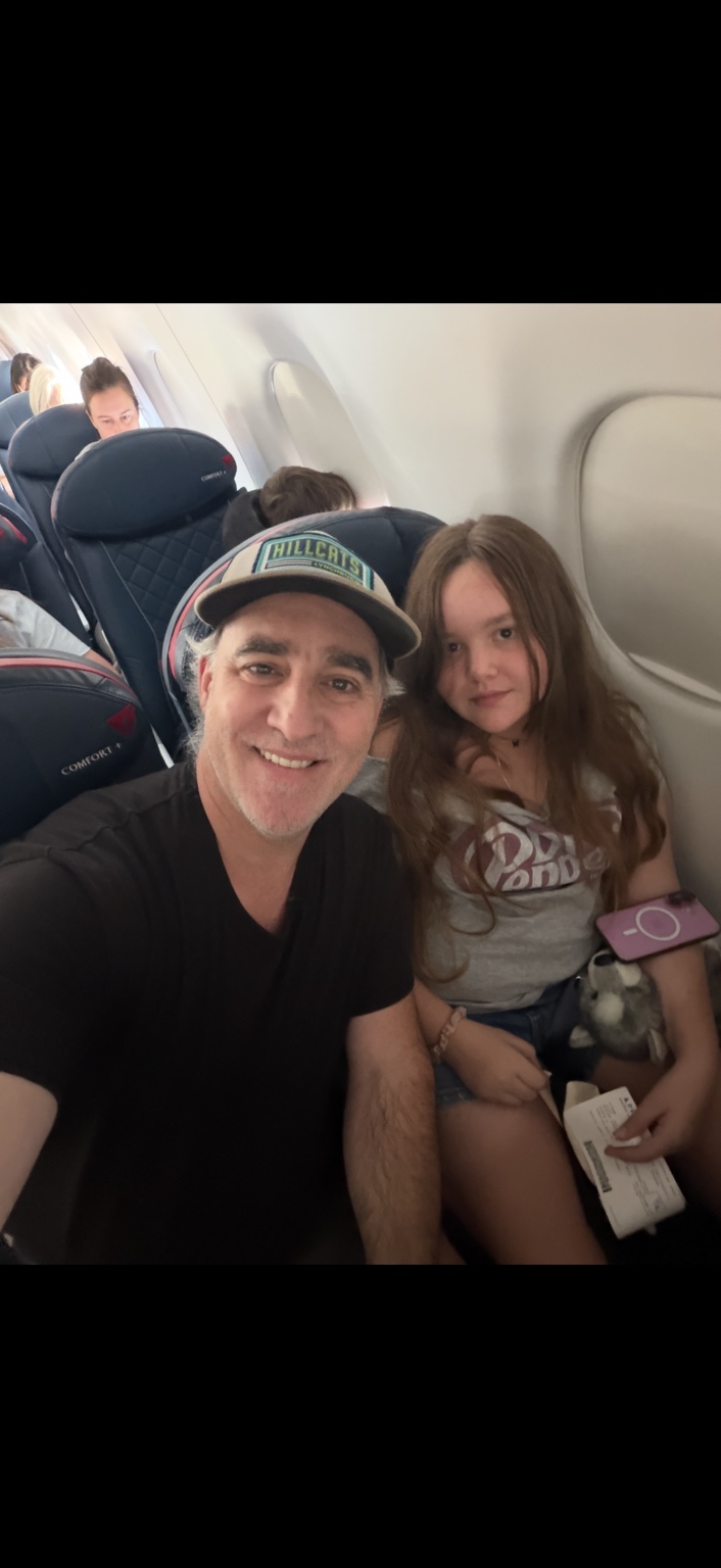 Leia traveling by airplane with her dad